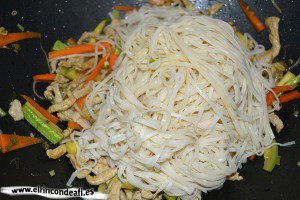 Tallarines con verduras, langostinos y cerdo al wok, añadir los tallarines y saltear