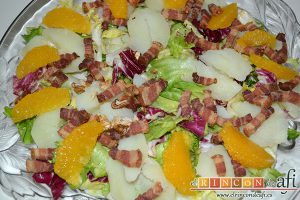 Ensalada variada con torreznos, ponemos los gajos de la naranja, los torreznos y las nueces troceadas
