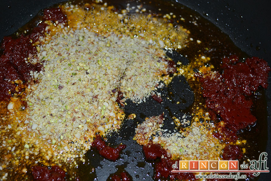 Pasta con pesto rojo y pechuga empanada, añadir los frutos secos triturados