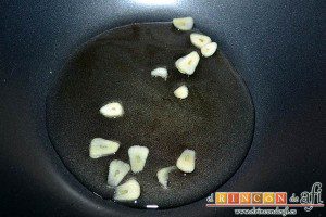 Gambones salteados con especias al wok, rehogar los ajos laminados en un wok con aceite de oliva bien caliente